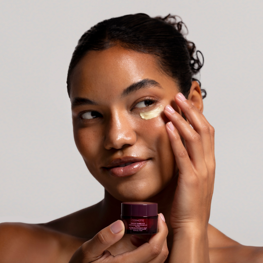Model applying Bright Embrace Brightening Eye Butter under eye area