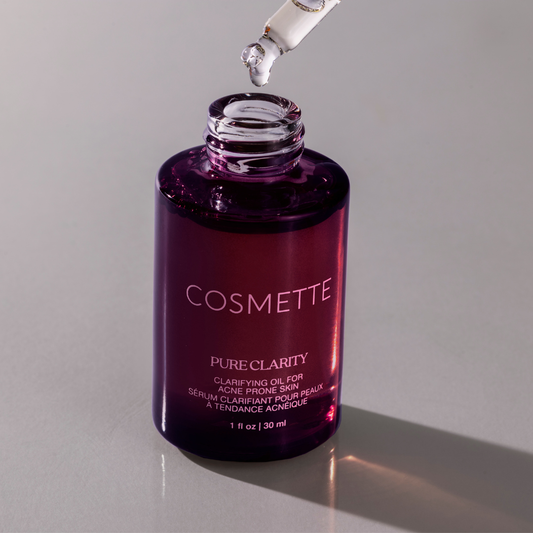 Cosmette Pure Clarity oil bottle with dropper on a gray background