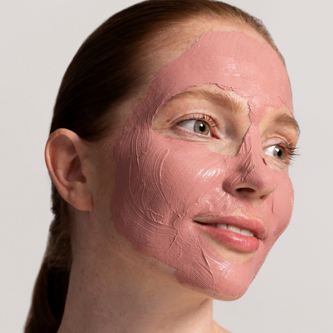 Woman with a Rosy Glow Mask her face against a plain background